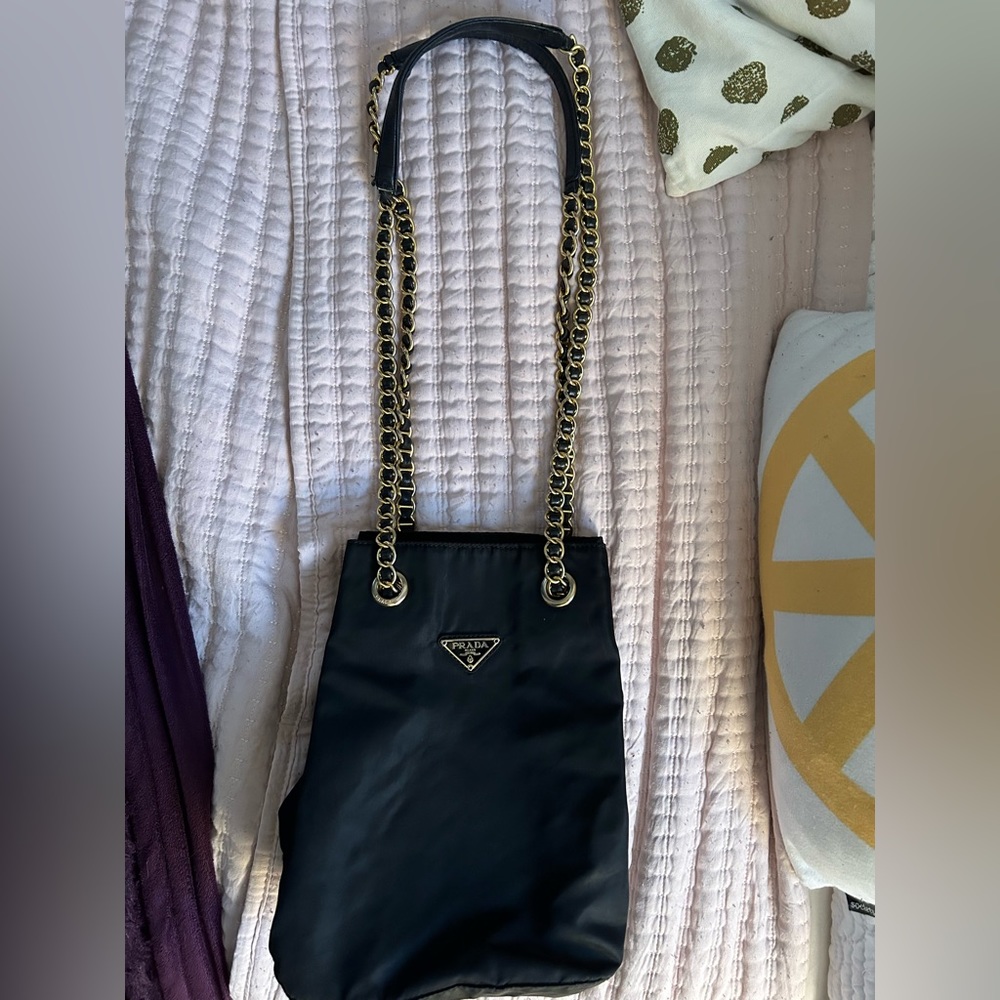Black with gold strap Prada purse used twice